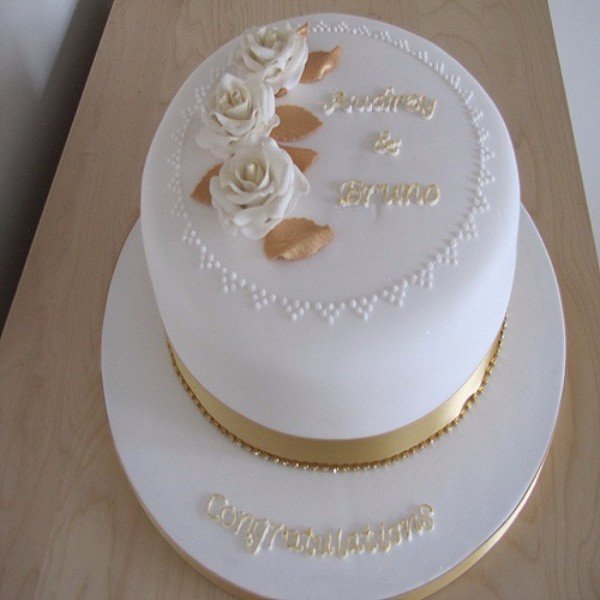 Victoria's Cake Design - A simple and elegant 50th Birthday cake. Bottom  tier is vanilla with buttercream and jam and the top tier is lemon sponge  with a fresh lemon buttercream. All